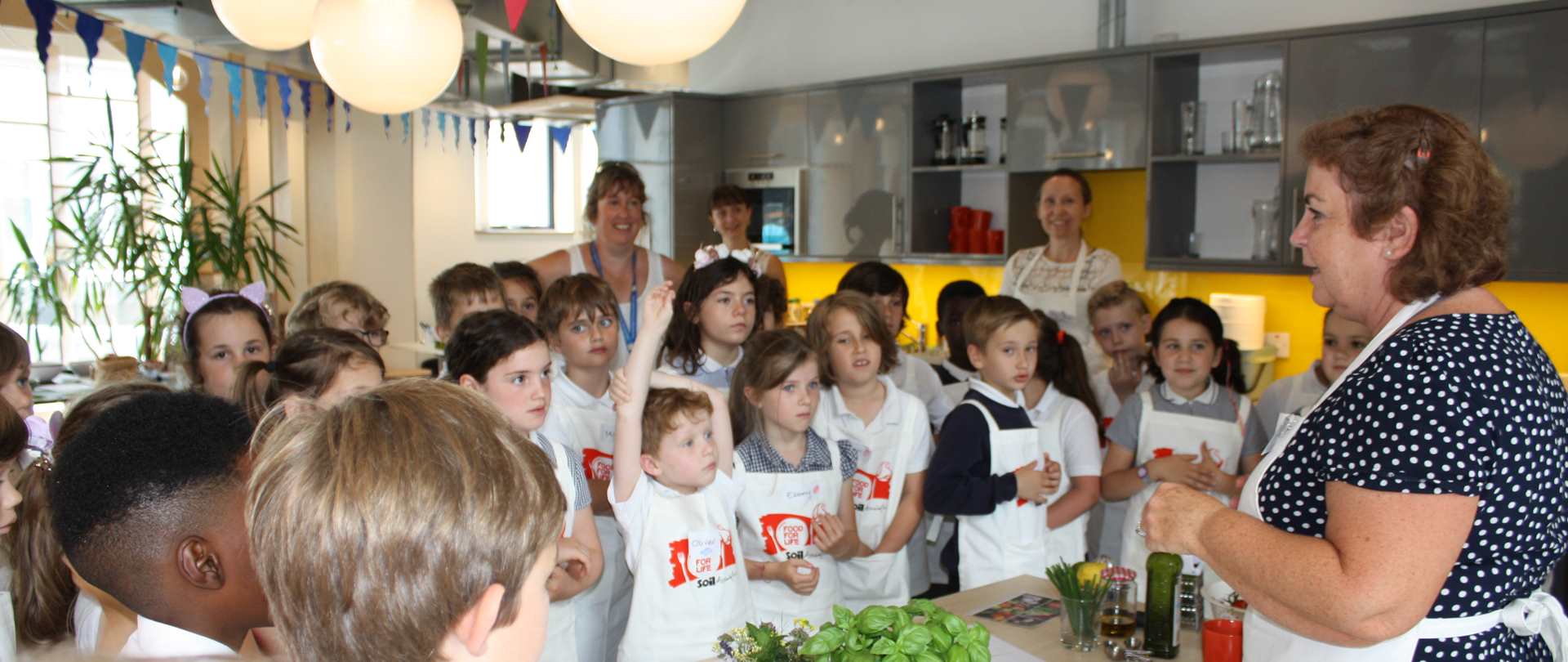 a group of children learning cooking skills