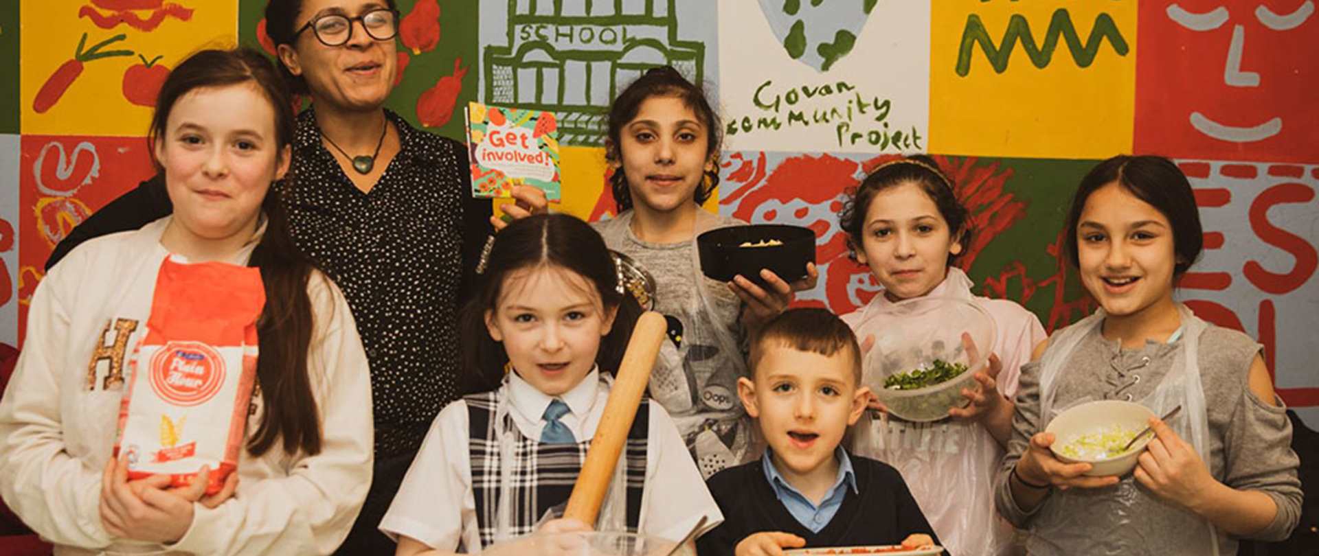 A group of children with a teacher cooking together